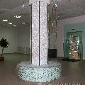   Водопады по стеклу в обрамлении несущей колонны. Торговый центр "Омега" г. Ижевск.